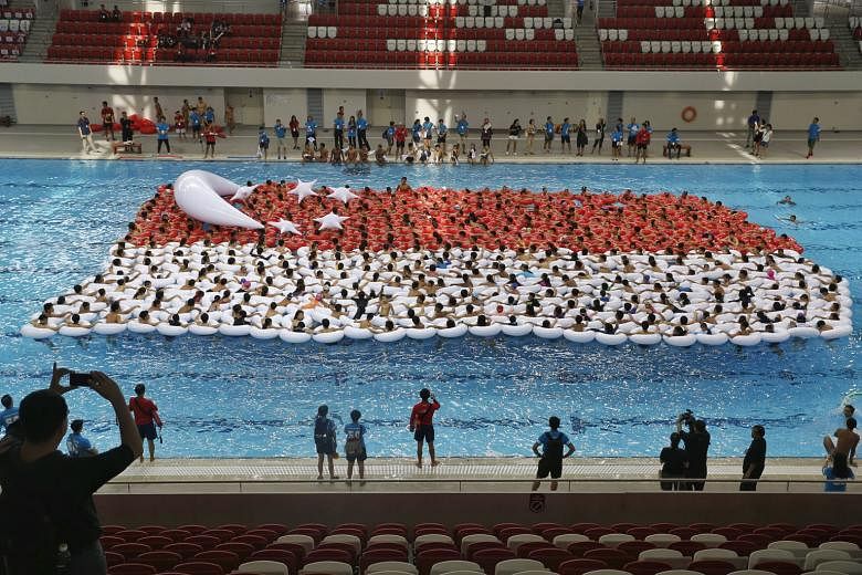 With their ring floats, 500 students got together yesterday in an attempt to set the record for Largest Floating Singapore Flag during a full rehearsal for the SG50 event Youth Celebrate! at the Singapore Sports Hub's OCBC Aquatic Centre. Minister fo