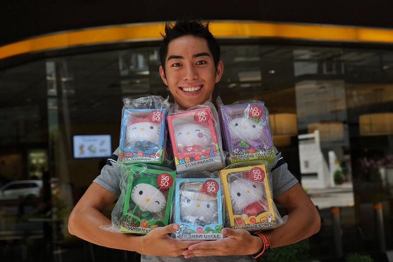 Mr Andreas Toh, 23, has his hands full with the six dolls in the limited- edition SG50 Hello Kitty set. His winning entry was a photograph of himself at the age of four, posing with the Ronald McDonald statue at King Albert Park McDonald's outlet.