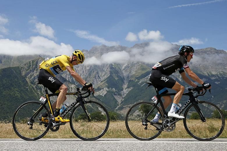 Team Sky riders Geraint Thomas (right) and Chris Froome, in the race leader's yellow jersey, during the 186.5km 18th stage from Gap to Saint-Jean- de-Maurienne in the French Alps on Thursday. Froome leads the overall standings by a seemingly unbeatab