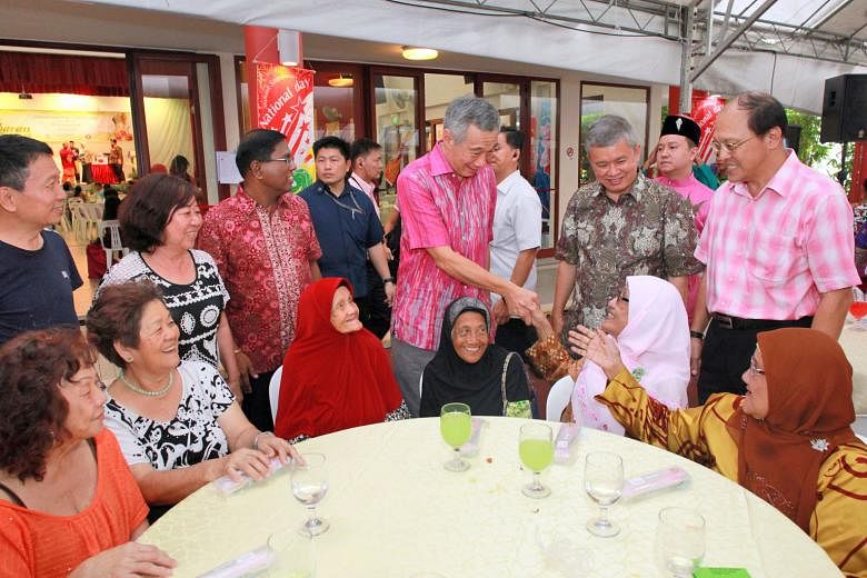 Prime Minister Lee Hsien Loong, with Ang Mo Kio GRC MP Ang Hin Kee (second from right) and grassroots leaders, meeting residents at Cheng San Community Club yesterday.