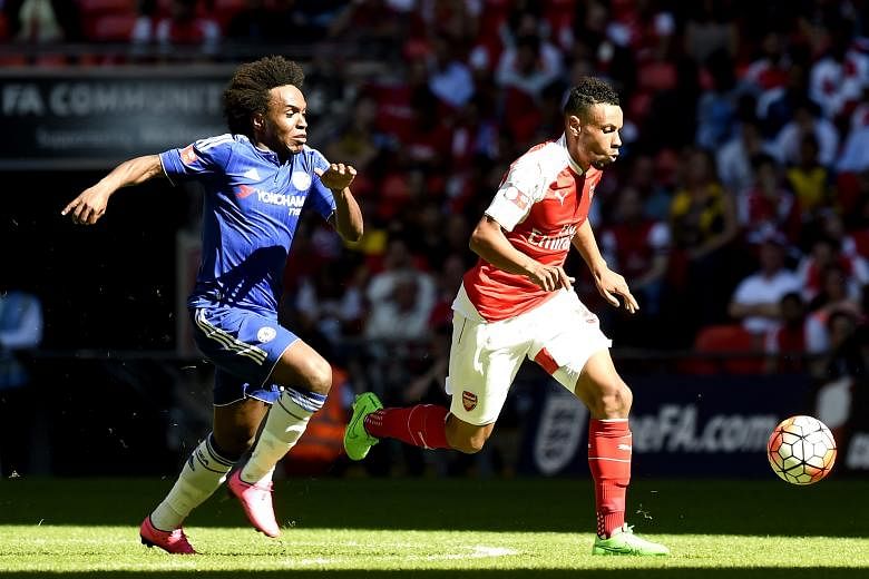Arsenal's Francis Coquelin (in red) gaining ground on Chelsea's Willian during last week's Community Shield. The emergence of the Frenchman has stemmed the Gunners' urge to go out and sign a holding midfielder.