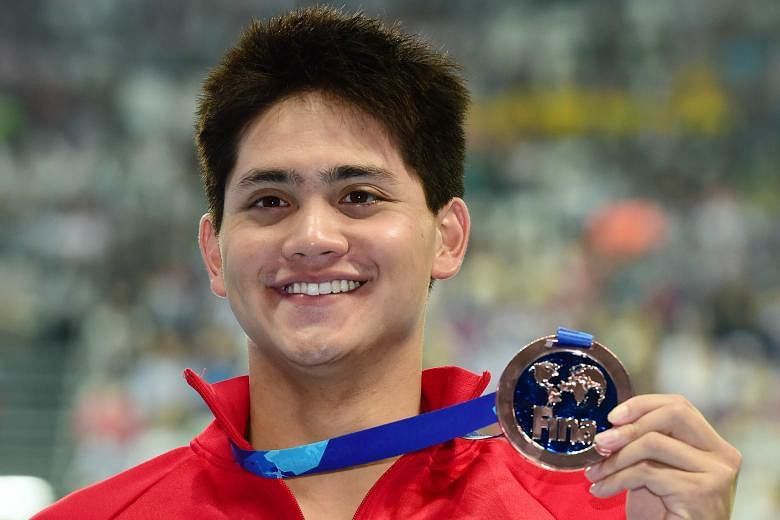 Joseph Schooling with his bronze medal for the 100m butterfly at the world championships yesterday. He clocked 50.96sec, a new Asian record, as he finished behind Chad le Clos (50.56) and Laszlo Cseh (50.87).