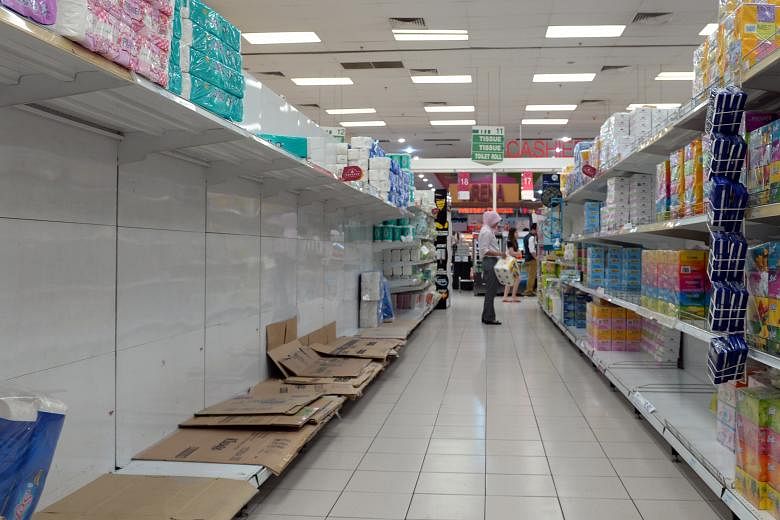 Empty shelves at a supermarket in Aeon Bukit Indah mall in Johor Baru after a scramble to stock up before the 6 per cent GST came into effect in April. Malaysia's gross domestic product is forecast to grow 4.5 per cent to 5.5 per cent this year, down