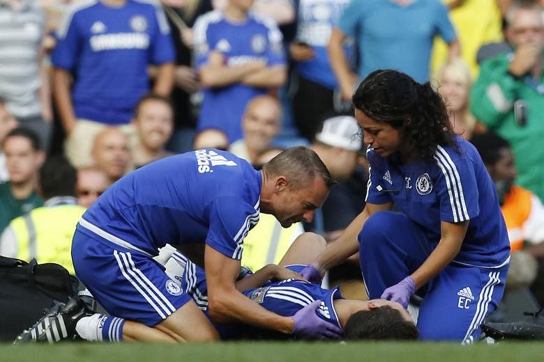 Chelsea doctor Eva Carneiro and head physio Jon Fearn attending to Eden Hazard against Swansea City last Saturday. The duo have received "universal and total support" from the Premier League Doctors' Group after the pair were criticised by manager Jo