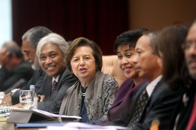 Bank Negara Malaysia governor Zeti Akhtar Aziz (with shawl) dismissed recent rumours of her resignation, insisting she would remain in office till her term ends next year. She also disclosed that seven of her officers were questioned by police over "