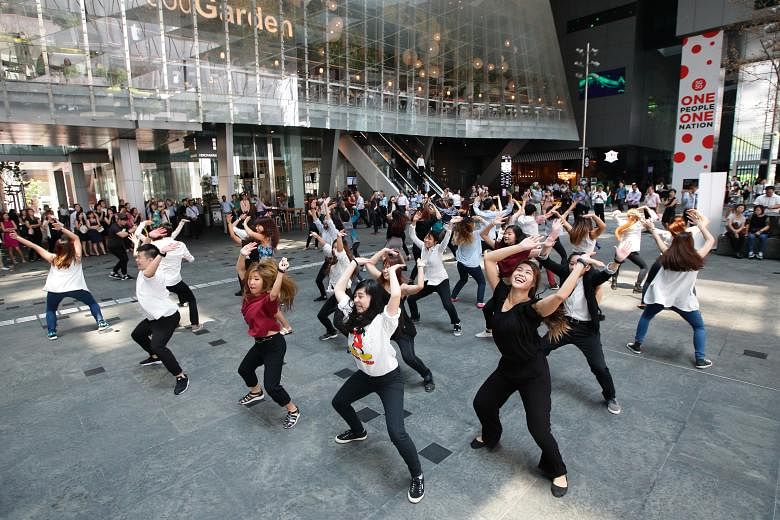 Dancers from O School dance school perform a mass dance at Asia Square at an event to launch Got To Move yesterday.