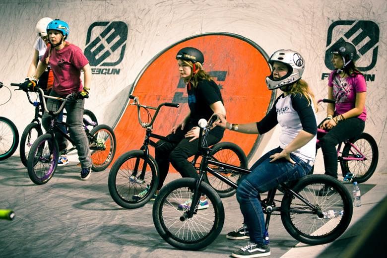 One of the films featured include Sister Session (2012, left) which follows an all-female team's foray into a bicycle motocross event.