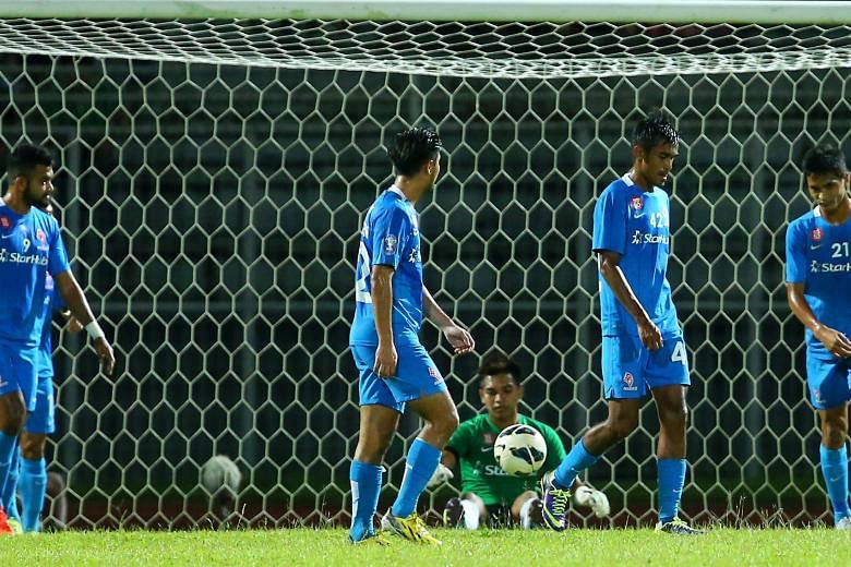 Goalkeeper Izwan Mahbud is dejected after poor marking by the LionsXII defenders allows Sarawak to capitalise on two corner kicks to find the net. The LionsXII have only one win to show for in 11 away MSL matches.