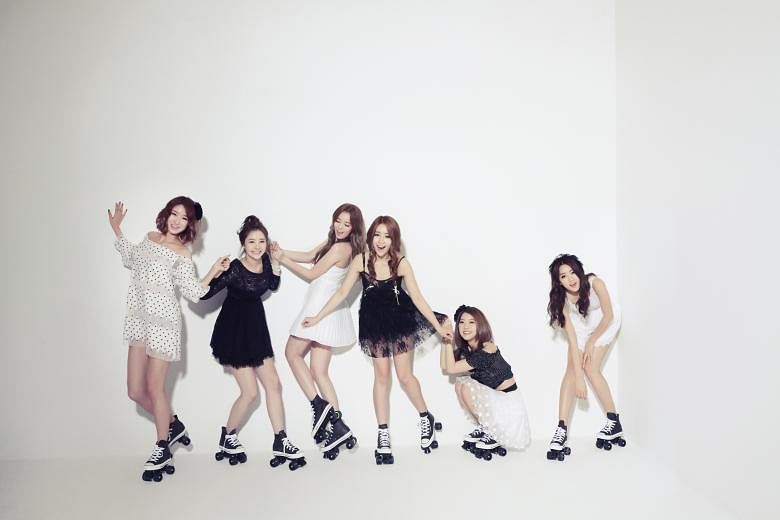 K-pop girl group Dal Shabet, comprising (from far left) Kaeun, Woohee, Serri, Jiyul, Ayoung and Subin, are headlining this Saturday's NTU Fest concert. Dal Shabet member Jiyul with local actress Julie Tan, who has recommended the group local delicaci