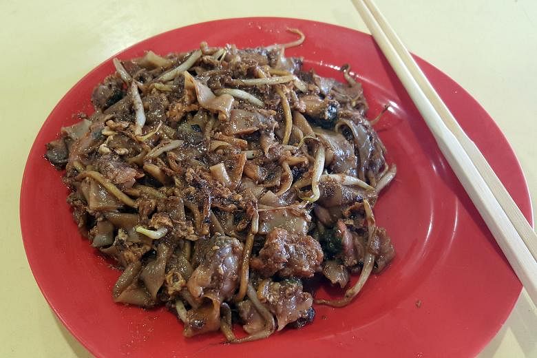 Hawker Loh Kwee Leng fries the noodles one plate at a time to control the quality.