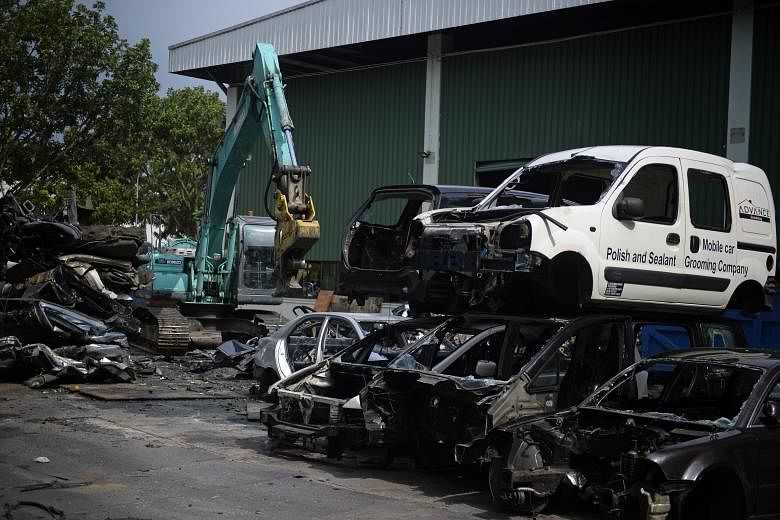 A car scrapyard in Sungei Kadut. Deregistered vehicles are supposed to be scrapped or exported, but falling overseas demand could be one reason why some motor traders risk not putting their deregistered cars in an export-processing zone, which charge