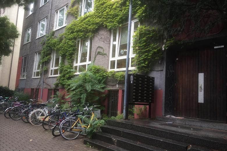 The facade of the four-storey former student dormitory that houses 52 refugees in Frankfurt's Westend area. (From left) Mrs Lina Ali, husband Ashraf and eldest child Salam. The family of six fled Syria separately and reunited in Germany.
