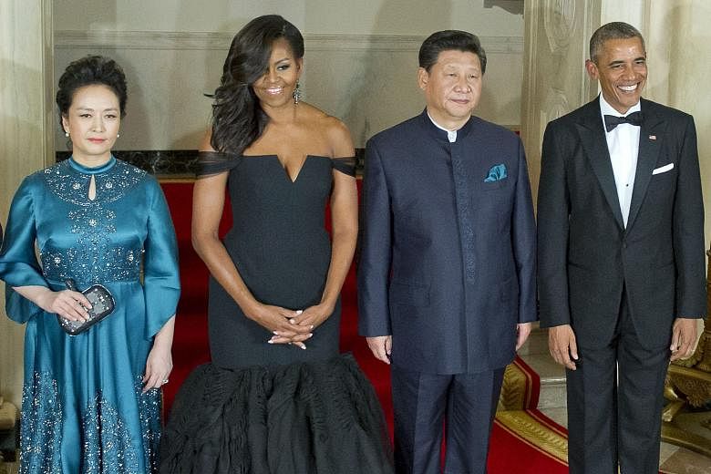 US President Barack Obama and Chinese President Xi Jinping posing for a photo at the White House on Friday with their spouses Michelle Obama and Peng Liyuan, prior to a state dinner in honour of Mr Xi's first state visit to the US capital. The Chines