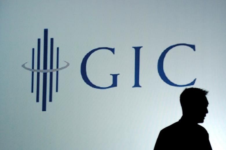 An employee silhouetted against the GIC logo. The fund was part of a consortium of investors that accounted for the biggest deal of the third quarter.