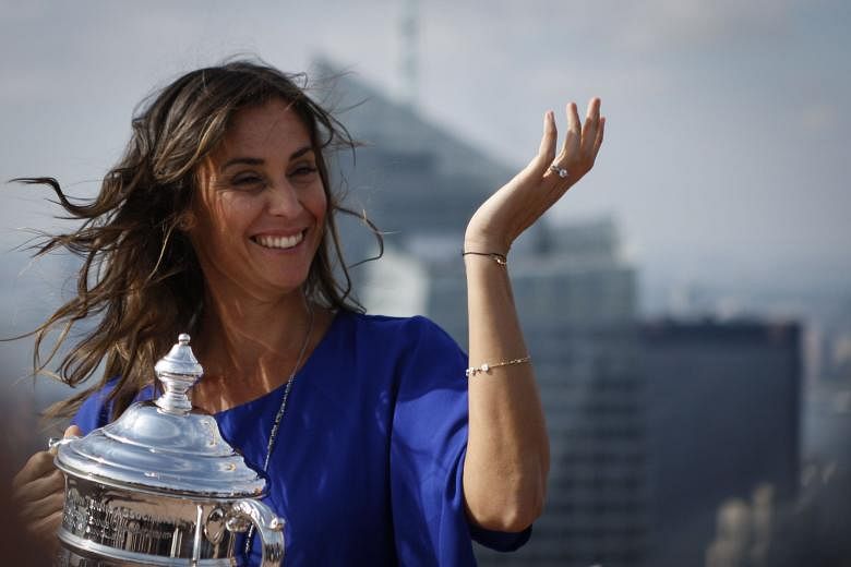 Flavia Pennetta at the Rockefeller Center's observation deck in New York City - with the US Open women's singles trophy on Sept 13. She is hoping to qualify for the WTA Finals in Singapore and end her career on a high note.