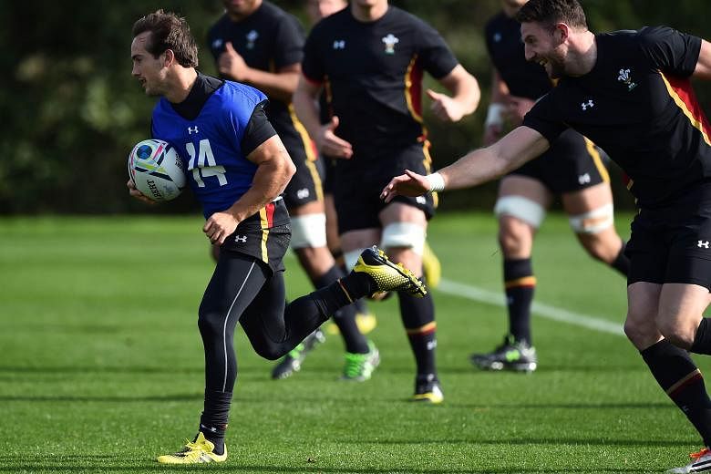 Wales' diminutive full-back Matthew Morgan (in blue vest) evading the challenge of his team-mate during a training session.