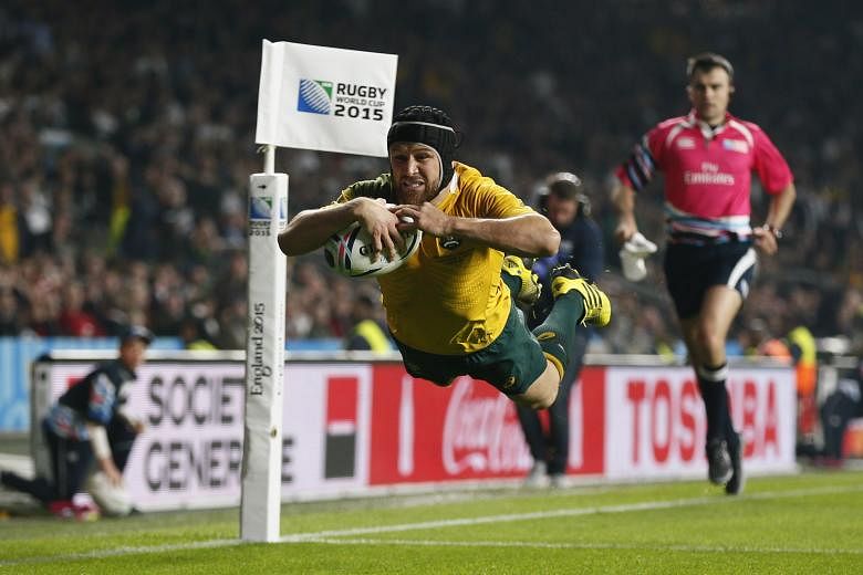 Australia's Matt Giteau scoring a try against England on Saturday. The Australians showed speed and determination to knock out the hosts.