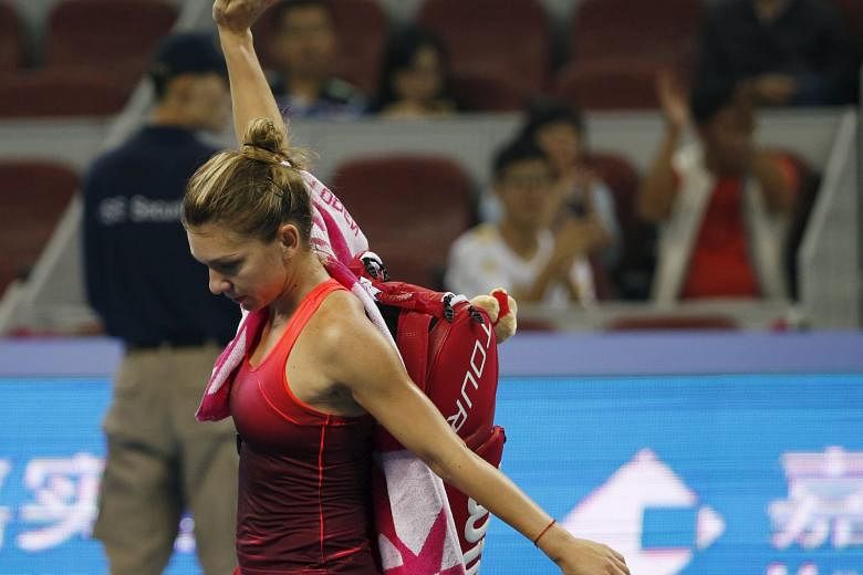 Simona Halep waving to spectators after retiring with a left-ankle injury yesterday.