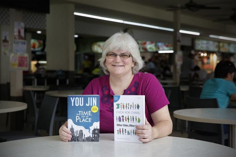 Ms Shelly Bryant at her "office", a Woodlands coffee shop, with books by You Jin and Chew Kok Chang that she translated into English.