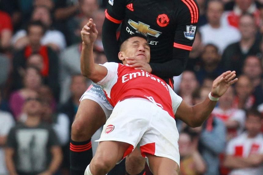 Above: Captain Wayne Rooney cuts a frustrated figure after United are outplayed and outwitted. Left: United defender Chris Smalling had to resort to roughhouse tactics in a bid to stop Arsenal forward Alexis Sanchez. But the Chilean has the last laug