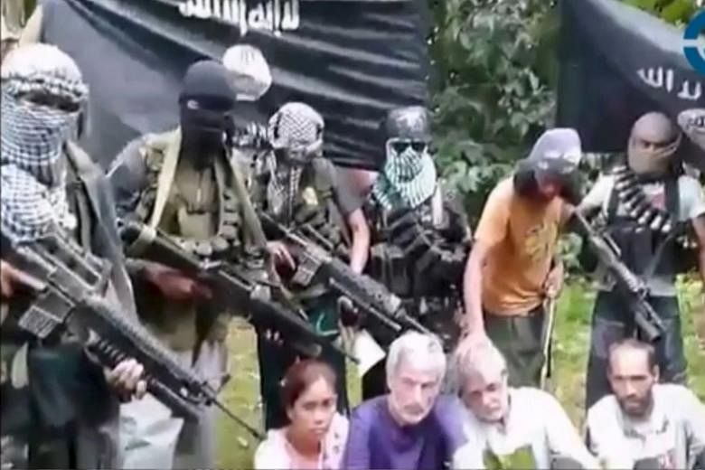 The four hostages, (from left) Ms Marites Flor, Mr Robert Hall, Mr John Ridsdel and Mr Kjartan Sekkingstad, appeared in a video on Tuesday. They were kidnapped after gunmen raided a luxury marina near Davao on Sept 21.