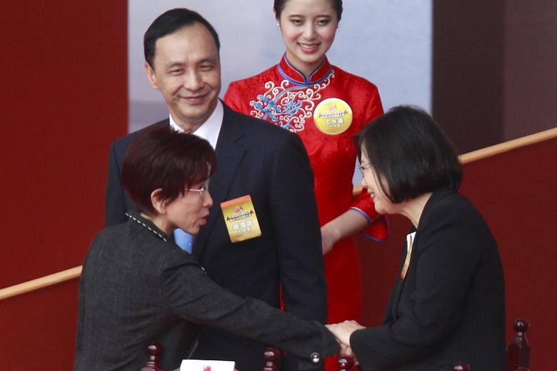 Taiwan's main opposition Democratic Progressive Party's presidential candidate Tsai Ing-wen (far right) shaking hands with the ruling Kuomintang's candidate for president Hung Hsiu-chu as KMT chairman Eric Chu looks on. The KMT is expected to lose th