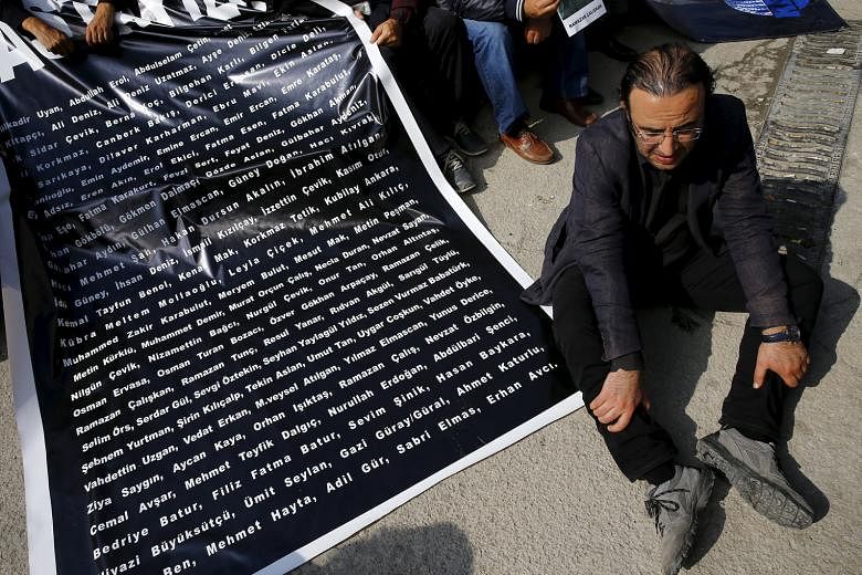 A man sitting beside a list of names of those killed in last Saturday's suicide bombings, during a commemoration event in Ankara. The latest attack has heaped pressure on the government, which is already under fire for failing to provide more informa