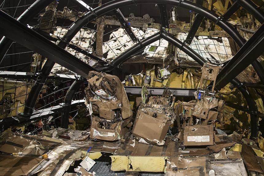 The partially reconstructed wreckage of the MH17 jet made of debris found strewn across eastern Ukraine. The Boeing 777 was hit by well over 800 high-energy objects, said the Dutch Safety Board.