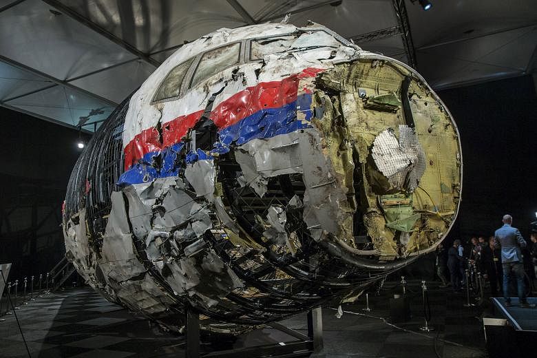 The partially reconstructed wreckage of the MH17 jet made of debris found strewn across eastern Ukraine. The Boeing 777 was hit by well over 800 high-energy objects, said the Dutch Safety Board.