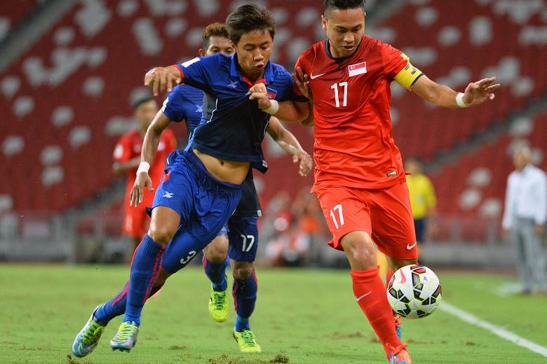 Shahril Ishak (No.17 in red) keeps Cambodia's Nen Sothearoth at bay in Singapore's 2-1 win in a World Cup qualifier at the National Stadium on Tuesday. He knows that a good performance for JDT II against the LionsXII tonight will boost his chances of