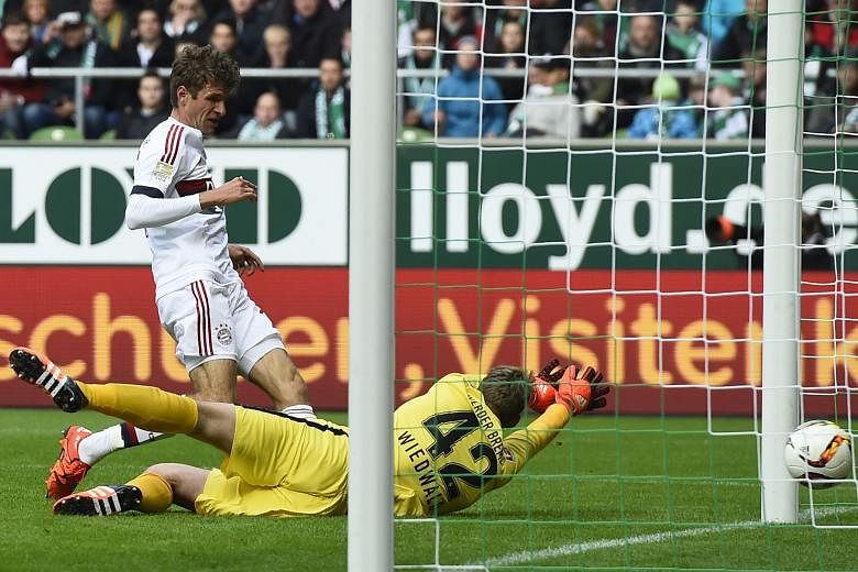 Bayern midfielder Thomas Mueller scoring past Bremen goalkeeper Felix Wiedwald for the only goal of their Bundesliga clash. Arsenal have their work cut out tomorrow.