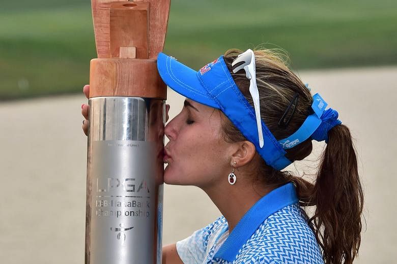 Lexi Thompson kissing the trophy after winning by a stroke in Incheon yesterday.