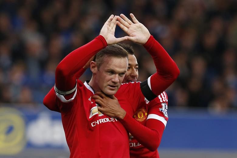 Captain Wayne Rooney getting a hug from team-mate Jesse Lingard after scoring Manchester United's third goal in their 3-0 win over Everton on Saturday. It was the English striker's first away goal in the Premier League since last November.
