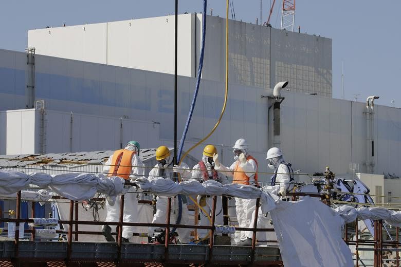 Workers setting up a barrier to prevent leakage of contaminated water at the Fukushima nuclear plant earlier this month. The latest news will likely inflame widespread public opposition to nuclear power.