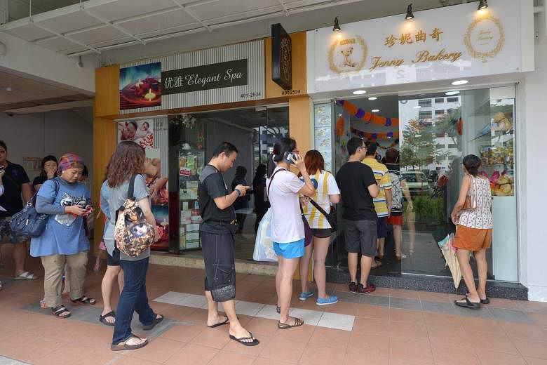 Customers eager for a taste of the famous Hong Kong cookies stood patiently in queue despite the heat and the haze.