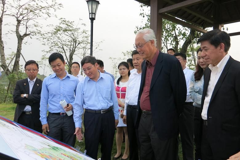 ESM Goh Chok Tong touring the Guangzhou Knowledge City yesterday. With him are (third from left) Mr Chen Zhiying, Party Secretary of Guangzhou Development District, Guangzhou Mayor Chen Jianhua (in white) and Sino-Singapore Guangzhou Knowledge City C