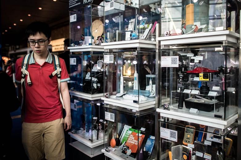 A display of electronic devices at the Hong Kong Electronics Fair in Hong Kong earlier this month. Many Asian countries see gloomy times ahead, having seen exports fall this year as compared with last year. In Singapore, nearly 40 per cent of electro