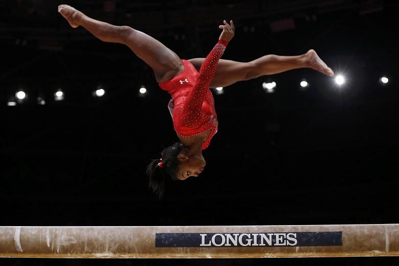 Simone Biles was not entirely perfect on the beam but her combined score - she trumped rivals on the vault and floor - was enough to claim her third consecutive world all-around crown.