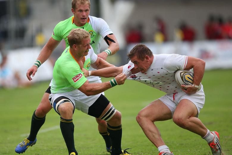 South Africa Sevens Academy team captain Kyle Brown (left) tackling an England Academy player en route to beating them 24-0 on day two of the Societe Generale Singapore Cricket Club International Rugby Sevens at the Padang. The tournament favourites 
