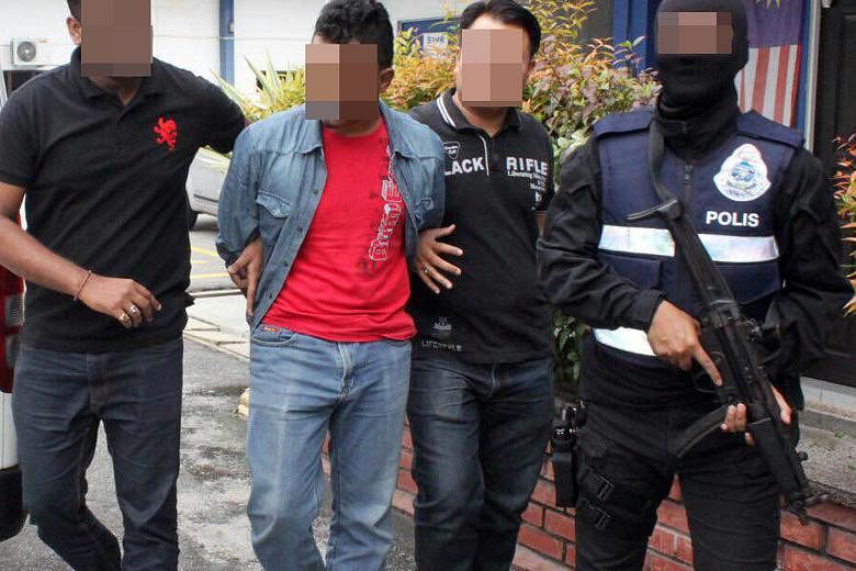 A suspect being arrested last Friday, during police swoops in Selangor, Perak and Johor.