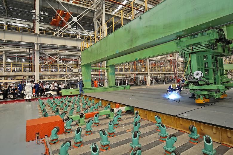 A steel-cutting demonstration at Sembcorp Marine's new steel structure fabrication workshop in Tuas, the biggest of its kind in South-east Asia. The rig-builder says investing in new capabilities and facilities will help ensure sustainable returns am