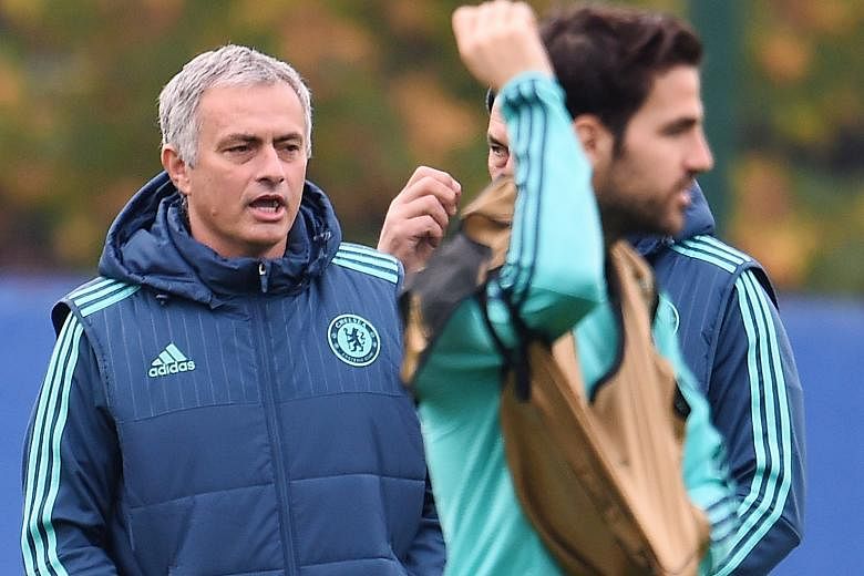 These are not happy days for Jose Mourinho (left), with Cesc Fabregas in training yesterday. He knows what is ailing Chelsea though he will not reveal details. But what is very apparent is that the Blues could be in danger of not making it to the kno