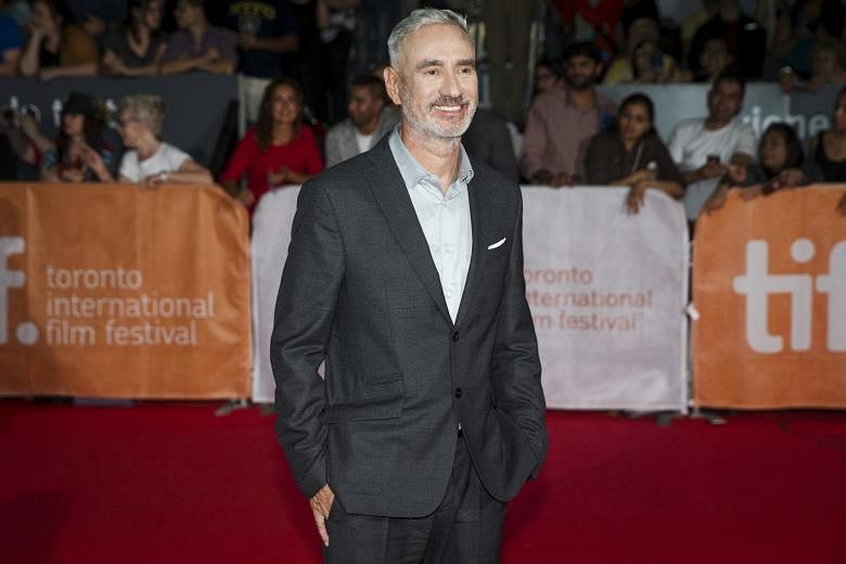 Director Roland Emmerich (left) at the Toronto Film Festival, where he was promoting his film, Stonewall, starring Jeremy Irvine (above).