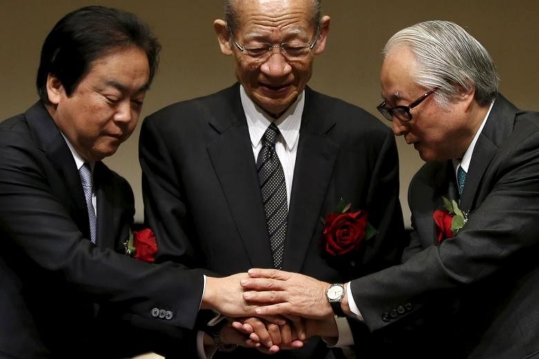 Japan Post Holdings president Taizo Nishimuro (centre), Japan Post Bank president Masatsugu Nagato (right) and Japan Post Insurance president Masami Ishii after a ceremony to mark the triple debut on the Tokyo Stock Exchange yesterday.