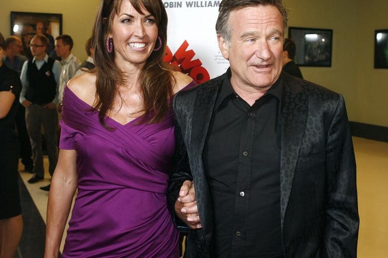Susan Schneider Williams laid the blame for her husband (both left) Robin Williams' suicide last year on diffuse Lewy body dementia.