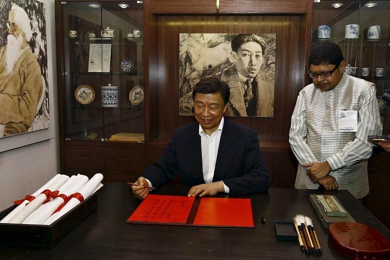 China's Vice-President Li Yuanchao after penning his entry in a visitor's book at the Chinese gallery of a museum during his visit to the ancestral house of Indian poet Rabindranath Tagore in Kolkata, India, yesterday. Mr Li is on a five-day official