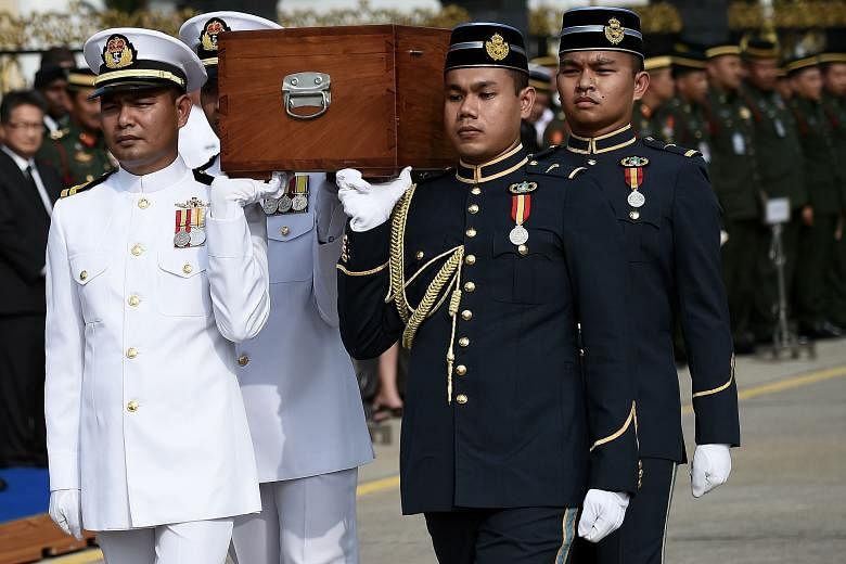 Malaysian troops bearing the presumed remains of the US airmen in a sombre ceremony in Kuala Lumpur yesterday. The airmen were on a flight to Malaysia on Nov 27, 1945, but never reached their destination.