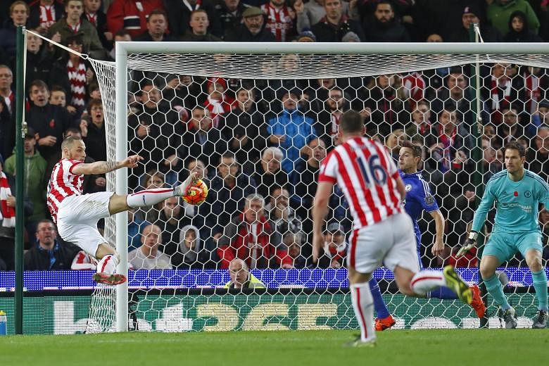 Stoke City's Marko Arnautovic scoring against Chelsea with a scissor kick in their Premier League encounter at Britannia Stadium on Saturday. The reigning champions are plagued by the fact that their forwards are unable to score while their defence h