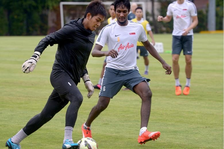 Madhu Mohana (right, with Izwan Mahbud) does not follow European football - even once referring to Shinji Kagawa as "the guy who played for Manchester United".