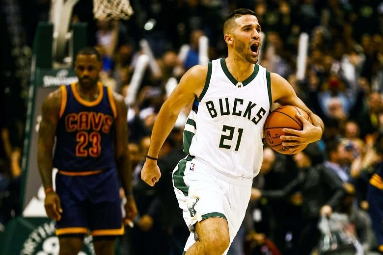 Milwaukee guard Greivis Vasquez of Venezuela whooping for joy as the final buzzer goes and the backboard lights up, while a despondent Cleveland forward LeBron James walks off the court. The Bucks won 108-105 in double overtime.